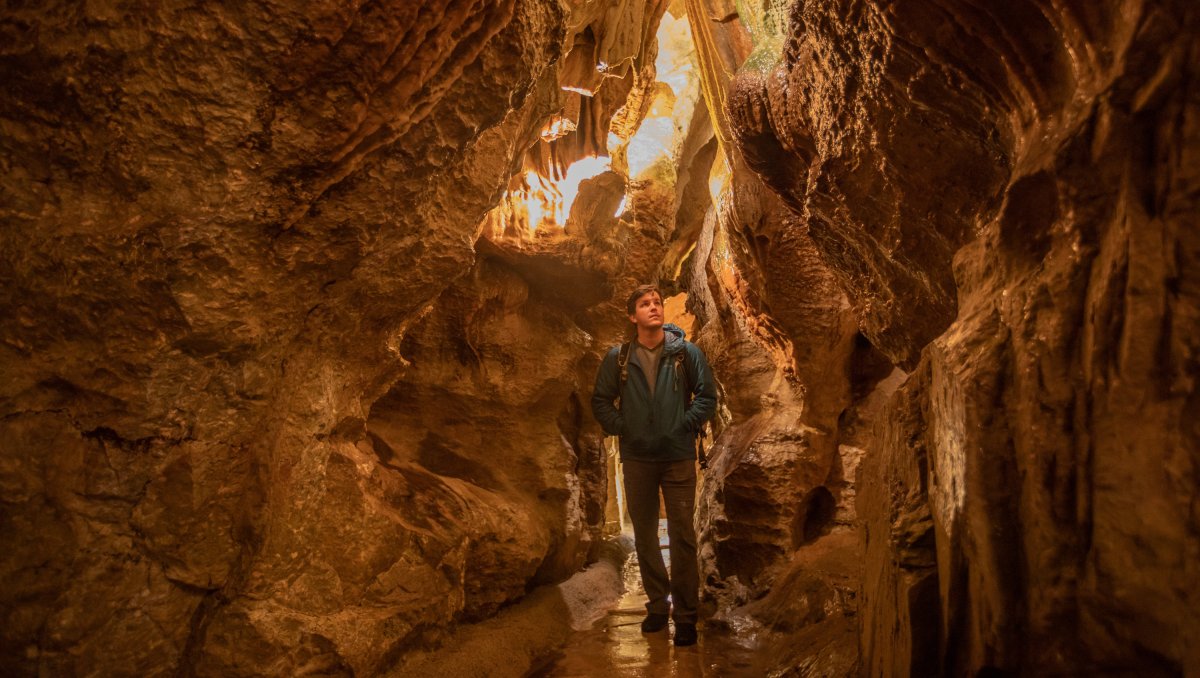 Man walking through Linville Caverns 